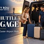 Traveler and shuttle driver beside suitcases and a golf travel bag at an airport pickup area.